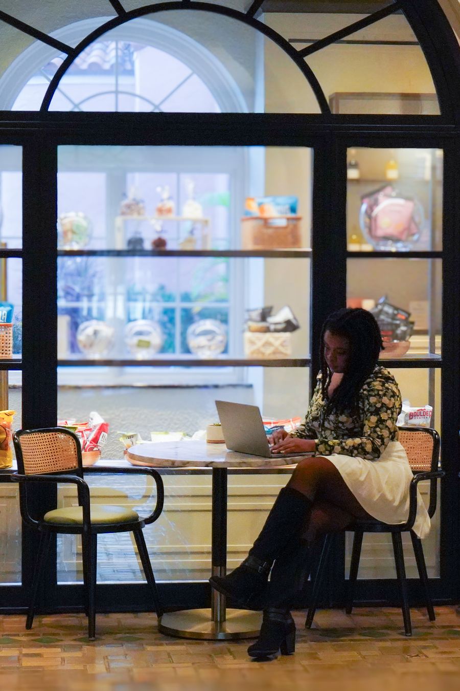Faye Constant working on a laptop in a hotel lounge