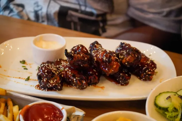 Glazed chicken wings served at Oak & Stone