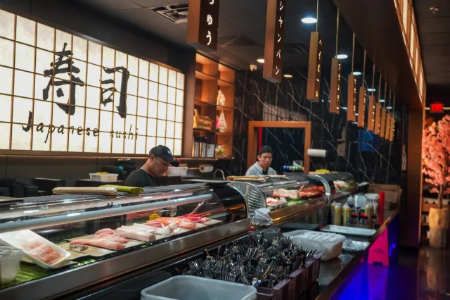 A wide view of the warmly lit sushi bar