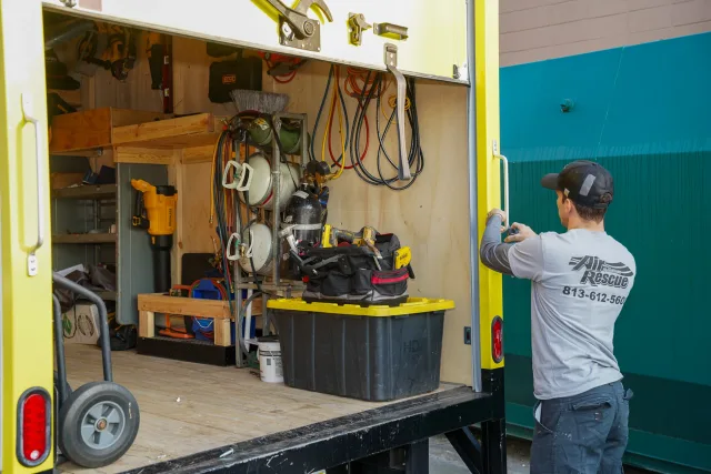 An Air Rescue technician organizing equipment in a service truck