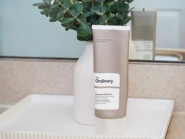 The Ordinary cleanser styled with a small vase and greenery