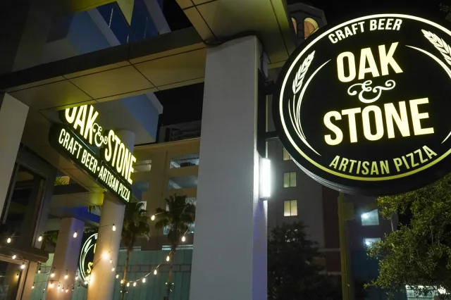 The illuminated Oak & Stone exterior after dark