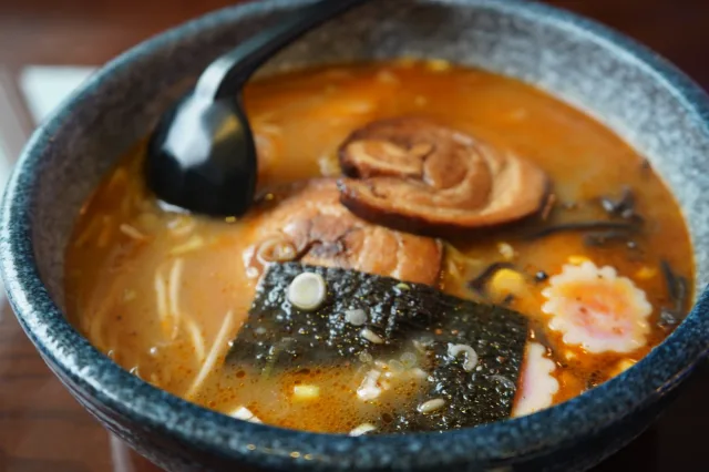 A bowl of ramen with mushrooms and egg