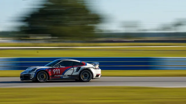 A numbered race car captured in motion along the circuit
