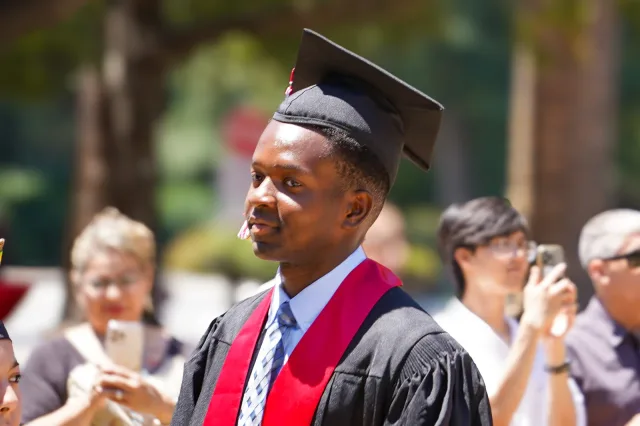 A graduate in cap and gown during the Stanford commencement ceremony
