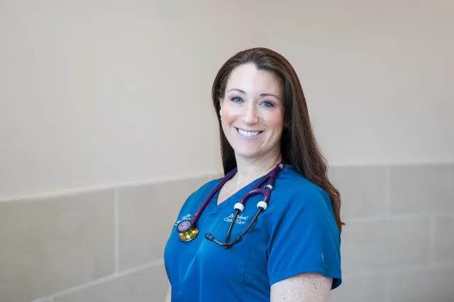 A smiling VMC team member wearing a stethoscope