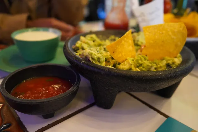 Fresh guacamole with a crisp tortilla chip