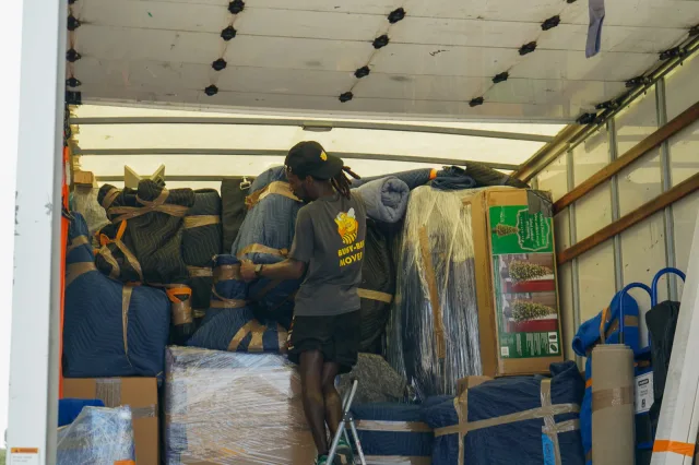 The moving truck neatly packed with secured furniture