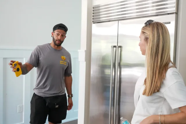 A mover discussing the job with a client inside a home