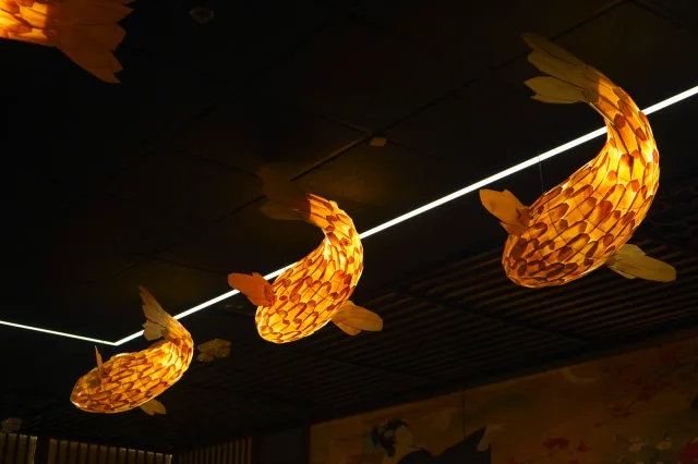 Warm crescent-shaped lights above the dining room