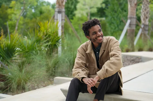A relaxed smiling portrait seated on the park steps